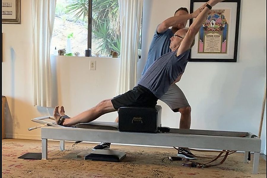 A one-to-one Pilates session in progress.